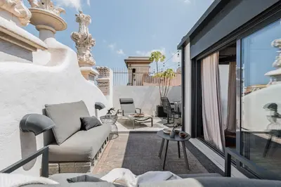 a balcony with a chair and a table at Aoraki - Penthouse and terraces in Eixample Dreta in Barcelona