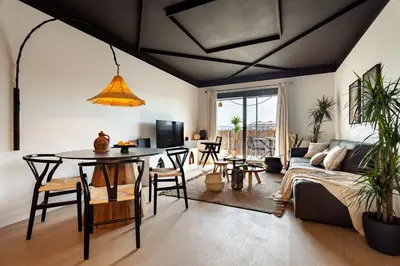 a living room with a table and a couch at Asrir - 2 bedroom, terrace and pool in Poblenou in Barcelona
