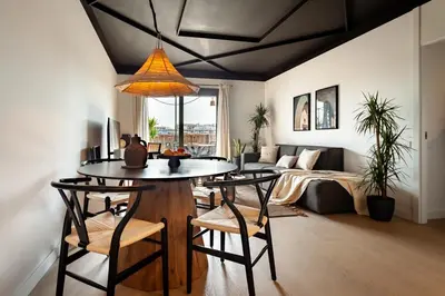 a living room with a couch and a tv at Asrir - 2 bedroom, terrace and pool in Poblenou in Barcelona
