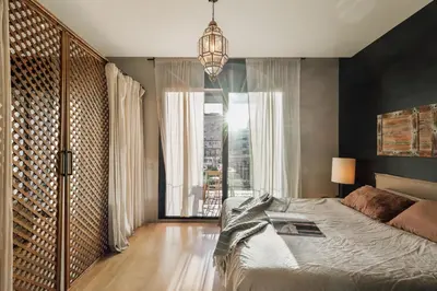 a bedroom with a large bed with black walls at Wabi - 2 bedrooms and terrace in Passeig de Gràcia in Barcelona