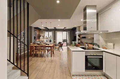 a home office with a desk and a laptop computer at Chalby - 4 bedrooms in Eixample Esquerra in Barcelona