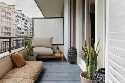 a balcony with a couch and potted plants at Talat - 3 bedrooms in Eixample Esquerra in Barcelona