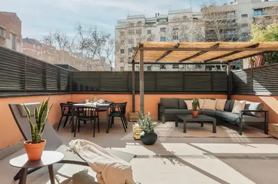 a dining room with a table and chairs and a staircase at Montsia - 3 bedrooms and a terrace in Les Corts in Barcelona