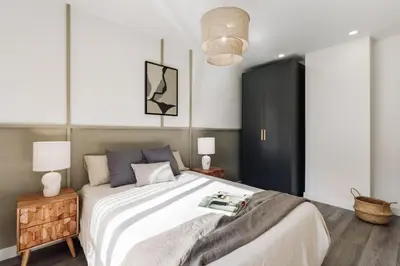 a white staircase in a home with a black stool at Montsia - 3 bedrooms and a terrace in Les Corts in Barcelona