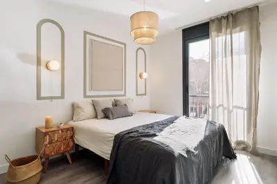 a bedroom with a large bed and a black cabinet at Montsia - 3 bedrooms and a terrace in Les Corts in Barcelona