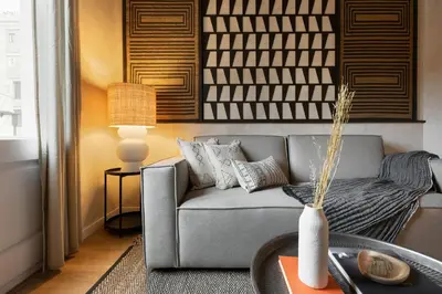 a dining room with a table with chairs and a mirror at Amourah - 2 bedrooms in Eixample Esquerra in Barcelona