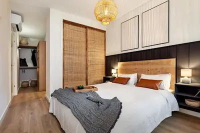 a bedroom with a large bed with a wooden headboard at Isilf - 2 bedrooms and balcony in Sant Gervasi in Barcelona