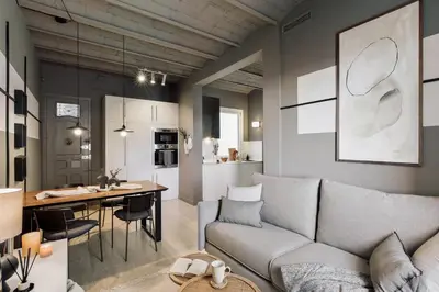 a kitchen with white cabinets and a wooden table at Pirineu - 2 bedrooms in Sant Gervasi in Barcelona