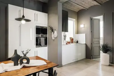 a living room with a couch and a tv at Pirineu - 2 bedrooms in Sant Gervasi in Barcelona