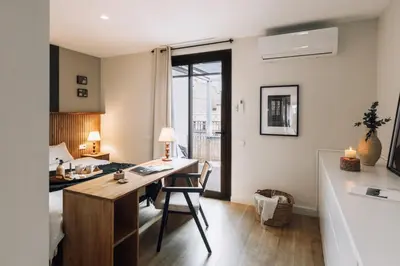 a bedroom with a bed with a book on it at Sultan - 2 bedrooms and terrace in Eixample Dreta in Barcelona