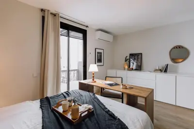 a bedroom with a bed and a mirror at Sultan - 2 bedrooms and terrace in Eixample Dreta in Barcelona