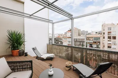 a balcony with a table and chairs and a hammock at Sultan - 2 bedrooms and terrace in Eixample Dreta in Barcelona