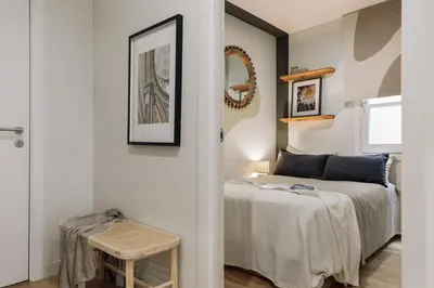 a bedroom with a large bed with a wooden headboard at Mescit - 2 bedrooms and balcony in Eixample Dreta in Barcelona