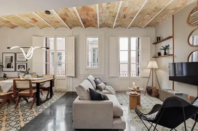 a living room with a couch and a tv at Salar - 2 bedrooms in Gràcia in Barcelona