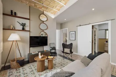 a living room with a couch and a tv at Salar - 2 bedrooms in Gràcia in Barcelona