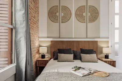 a living room with a couch and a kitchen at Salar - 2 bedrooms in Gràcia in Barcelona