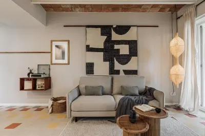 a living room with a couch and a table at Pacaya - 2 bedrooms, office and balcony in Eixample Dreta in Barcelona
