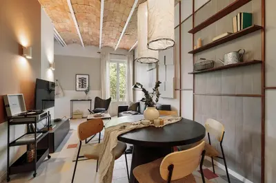 a living room with a table and chairs at Indiana - 2 bedrooms, office and balcony in Eixample Dreta in Barcelona