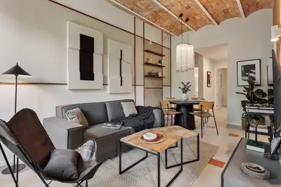 a bedroom with a large bed and a brick wall at Indiana - 2 bedrooms, office and balcony in Eixample Dreta in Barcelona