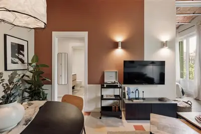 a living room with a couch and a bed at Indiana - 2 bedrooms, office and balcony in Eixample Dreta in Barcelona