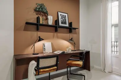 a living room with a large television and a table at Indiana - 2 bedrooms, office and balcony in Eixample Dreta in Barcelona