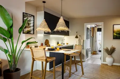 a kitchen and living room with a table and a couch at Batam - 1 bedroom and terrace in Gràcia in Barcelona
