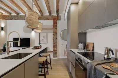 a living room and kitchen with a couch and a table at Minchin - 1 bedroom, balcony and pool in Poblenou in Barcelona