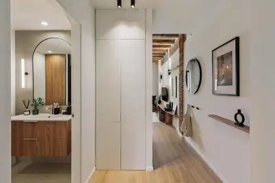 a bedroom with a bed with two arches on the wall at Minchin - 1 bedroom, balcony and pool in Poblenou in Barcelona