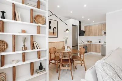 a dining room table with a vase of flowers on it at Stabia - 2 bedrooms in Sant Gervasi in Barcelona