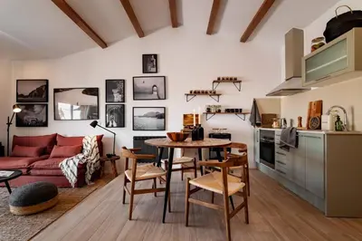 a kitchen and dining room with a table and chairs at Hassi - 2 bedrooms and terrace in Gràcia in Barcelona