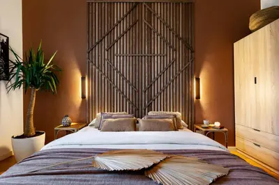 a rattan chair with pillows in a living room at Sumbawa - 2 bedrooms in Eixample Dreta in Barcelona