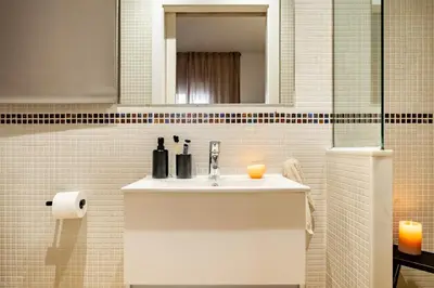 a bathroom with a sink and a mirror at Finnt - 1 bedroom and terrace in Eixample Dreta in Barcelona