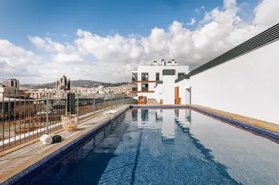 a wooden wall with two doors on a deck at Idir - 2 bedrooms, a pool and terrace in Poblenou in Barcelona