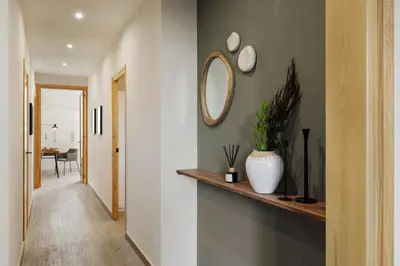 a kitchen with white cabinets and a wooden counter top at Chixoy - 3 bedrooms and balcony in Eixample Dreta in Barcelona