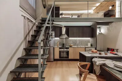 a kitchen with a spiral staircase in a loft at Thar - 1 bedroom in Ciutat Vella in Barcelona
