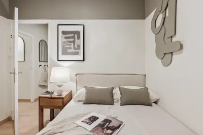 a bedroom with a large bed with two lamps at Izabal - 3 bedrooms and office in Eixample Esquerra in Barcelona
