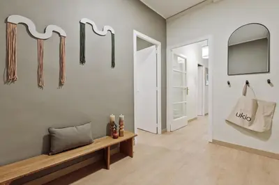 a hallway with umbrellas hanging on a wall at Izabal - 3 bedrooms and office in Eixample Esquerra in Barcelona
