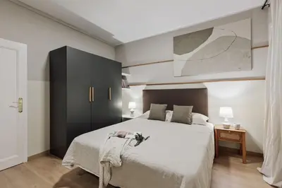 a living room with a table and a couch at Izabal - 3 bedrooms and office in Eixample Esquerra in Barcelona