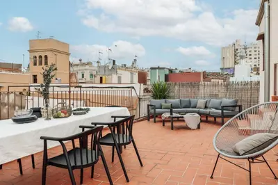 a living room with a couch and a table at Marmara - 3 bedrooms and terrace in Sant Pere in Barcelona
