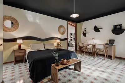 a bedroom with a large bed and a mirror at Marmara - 3 bedrooms and terrace in Sant Pere in Barcelona