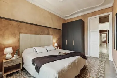 a dining room with a table with an orange vase on it at Erfoud - 3 bedrooms in Gràcia in Barcelona