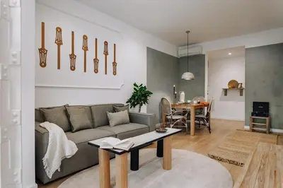 a kitchen with white cabinets and a refrigerator at Alhamilla - 1 bedroom in Eixample Dreta in Barcelona
