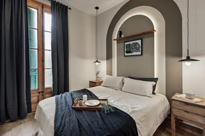a bedroom with a bed and a chair and a window at Walla - 3 bedrooms and balcony in Eixample Dreta in Barcelona