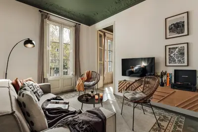a small kitchen with wooden cabinets and a sink at Hunde - 2 bedrooms in Eixample Esquerra in Barcelona