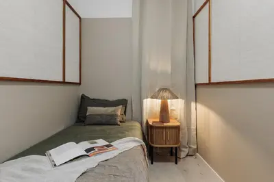 a bedroom with a bed with a book on it at Drago - 3 bedrooms and balcony in Les Corts in Barcelona