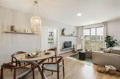 a living room with a table and chairs and a tv at Gragnano - 2 bedrooms in Poblenou in Barcelona