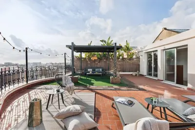a patio with chairs and tables and a pavilion at Tossa - 2 bedroom and terrace in Eixample Esquerra in Barcelona