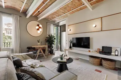 a living room with a couch and a tv at Uyuni - 2 bedrooms and balcony in Eixample Dreta in Barcelona
