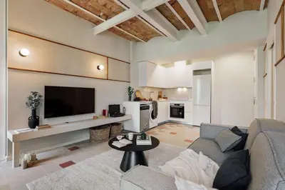 a living room with a table and a couch at Uyuni - 2 bedrooms and balcony in Eixample Dreta in Barcelona