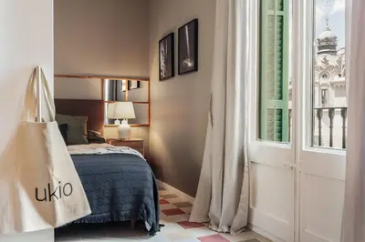 a bedroom with a large headboard with two lamps at Uyuni - 2 bedrooms and balcony in Eixample Dreta in Barcelona
